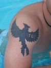 tribal phoenix on man's shoulder